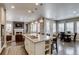 Spacious kitchen island with seating, flowing into a comfortable living area with fireplace at 8444 E 55Th Pl, Denver, CO 80238