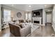 Comfortable living room with fireplace, modern decor, and hardwood floors at 8444 E 55Th Pl, Denver, CO 80238