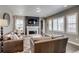 Comfortable living room featuring a fireplace, neutral decor, and plenty of natural light at 8444 E 55Th Pl, Denver, CO 80238