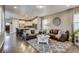 Spacious living room view to open kitchen featuring leather couches and modern decor at 8444 E 55Th Pl, Denver, CO 80238