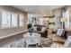 Comfortable living area featuring hardwood floors, a kitchen view, and stylish decor at 8444 E 55Th Pl, Denver, CO 80238