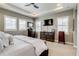 Serene primary bedroom with tray ceiling, multiple windows, and a neutral color palette at 8444 E 55Th Pl, Denver, CO 80238