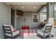 Covered patio with seating, a red and white rug, plus a flatscreen TV, and an outdoor grill at 8444 E 55Th Pl, Denver, CO 80238