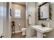 Well-appointed powder room featuring a stylish mirror and fixtures at 8444 E 55Th Pl, Denver, CO 80238
