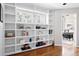 Home office with custom built-in shelving, hardwood floors, and bright, natural light at 407 S White Tail Dr, Franktown, CO 80116