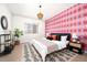 Main bedroom with patterned wall and cozy bedding at 5363 Quail St, Arvada, CO 80002