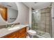 Bathroom featuring a wood vanity, stone countertop, toilet, and a glass-enclosed shower at 2227 Canyon Blvd # 312A, Boulder, CO 80302