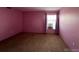 Simple bedroom with pink walls and carpeted floors at 2227 Canyon Blvd # 312A, Boulder, CO 80302