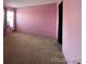 Spacious bedroom with pink walls and wall-to-wall carpet at 2227 Canyon Blvd # 312A, Boulder, CO 80302