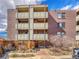 Exterior of brick building with multiple balconies and mature landscaping around walkway at 2227 Canyon Blvd # 312A, Boulder, CO 80302