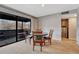 A dining area near sliding doors to the balcony with hardwood chairs at 2227 Canyon Blvd # 312A, Boulder, CO 80302