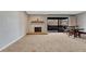 Living room with sliding doors to the balcony, fireplace, and carpet flooring at 2227 Canyon Blvd # 312A, Boulder, CO 80302