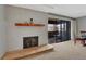 Carpeted living room featuring a fireplace, mantel and sliding glass doors to the balcony at 2227 Canyon Blvd # 312A, Boulder, CO 80302