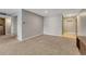 An empty living room with neutral paint, carpet flooring and a doorway to the hall at 2227 Canyon Blvd # 312A, Boulder, CO 80302