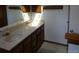 Bright bathroom featuring a dual sink vanity with a marble countertop and oak cabinets at 11772 E Adriatic Pl, Aurora, CO 80014