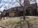 Charming two-story home with brick and siding, featuring a well-manicured lawn and mature trees at 11772 E Adriatic Pl, Aurora, CO 80014