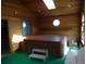 Relaxing hot tub room with wood paneling, offering a private spa experience and natural light at 11772 E Adriatic Pl, Aurora, CO 80014