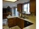 Functional kitchen with classic wood cabinets and a scenic view, offering a practical space for cooking at 11772 E Adriatic Pl, Aurora, CO 80014