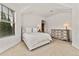 Bedroom featuring white walls, a large window, neutral carpet, and a wooden dresser at 1027 S Fillmore Way, Denver, CO 80209