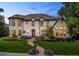 Elegant white brick home features manicured lawn, lush landscaping and timeless architectural design at 1027 S Fillmore Way, Denver, CO 80209