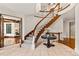 Grand foyer showcases a curved staircase, elegant tile flooring and sophisticated architectural details at 1027 S Fillmore Way, Denver, CO 80209