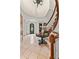 Spacious foyer features tile flooring, curved staircase, and decorative accents for a grand entrance at 1027 S Fillmore Way, Denver, CO 80209