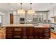 Open kitchen design with custom island with granite top and wine cooler, and stainless steel appliances at 1027 S Fillmore Way, Denver, CO 80209