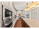 Contemporary kitchen features stainless steel appliances, sleek counters, and custom cabinets, creating a modern space at 1027 S Fillmore Way, Denver, CO 80209