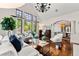 Elegant living room boasts high ceilings, large windows, and a view of the outdoor scenery at 1027 S Fillmore Way, Denver, CO 80209