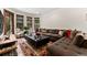 Comfortable living room with plush sectional sofa, decorative rug, and ample natural light from the windows at 1027 S Fillmore Way, Denver, CO 80209