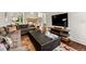 Inviting living room with a fireplace, TV, and stylish decor creating a cozy and relaxing space at 1027 S Fillmore Way, Denver, CO 80209