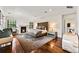 Spacious main bedroom with a fireplace, seating area, and hardwood floors provides a comfortable retreat at 1027 S Fillmore Way, Denver, CO 80209