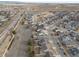 An aerial view of the house and the surrounding neighborhood featuring green spaces at 2317 Winding Dr, Longmont, CO 80504