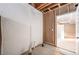 Unfinished basement showing framing and utilities, leading to a finished room with carpet at 2317 Winding Dr, Longmont, CO 80504