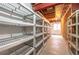 Unfinished basement storage with industrial shelves and exposed ceiling at 2317 Winding Dr, Longmont, CO 80504