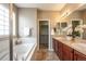 Relaxing bathroom with double vanity, soaking tub, and linen closet at 2317 Winding Dr, Longmont, CO 80504