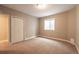 A finished bedroom has neutral carpet, a closet, and a window for light at 2317 Winding Dr, Longmont, CO 80504