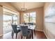 Charming dining room features a sliding glass door and stylish blue chairs at 2317 Winding Dr, Longmont, CO 80504