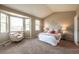 Cozy main bedroom with a sitting area near a large window offering ample natural light at 2317 Winding Dr, Longmont, CO 80504