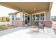 Cozy outdoor patio with comfortable seating and a charming view of the green backyard and surrounding landscape at 2317 Winding Dr, Longmont, CO 80504