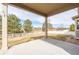 Covered patio provides shade and a view of the spacious backyard and trees at 2317 Winding Dr, Longmont, CO 80504