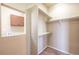 Walk-in closet with custom shelving and a laundry area to the side at 2317 Winding Dr, Longmont, CO 80504