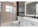 Bathroom featuring a tiled shower, vanity with marble top, and neutral tones at 8012 S Cedar St, Littleton, CO 80120