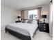 Stylish bedroom with two windows, neutral walls, and elegant bedside tables at 8012 S Cedar St, Littleton, CO 80120