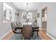 Dining room featuring a large table, seating for six, and a bay window at 8012 S Cedar St, Littleton, CO 80120