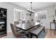 Dining room with hardwood floors, seating for six, and modern light fixture at 8012 S Cedar St, Littleton, CO 80120