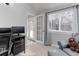 Well-lit home office with French doors, a view of the outdoors, and a comfortable seating area at 8012 S Cedar St, Littleton, CO 80120