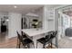 Modern kitchen with white counters, stainless steel appliances and barstool seating at 8012 S Cedar St, Littleton, CO 80120