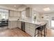 Bright kitchen featuring white cabinets, stainless steel appliances, and hardwood floors at 8012 S Cedar St, Littleton, CO 80120