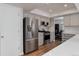 Modern kitchen with stainless steel appliances, white cabinets, and hardwood floors at 8012 S Cedar St, Littleton, CO 80120